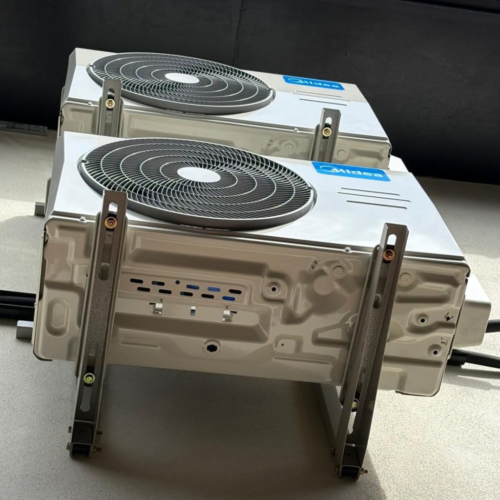 An air conditioning unit on its side awaiting repair