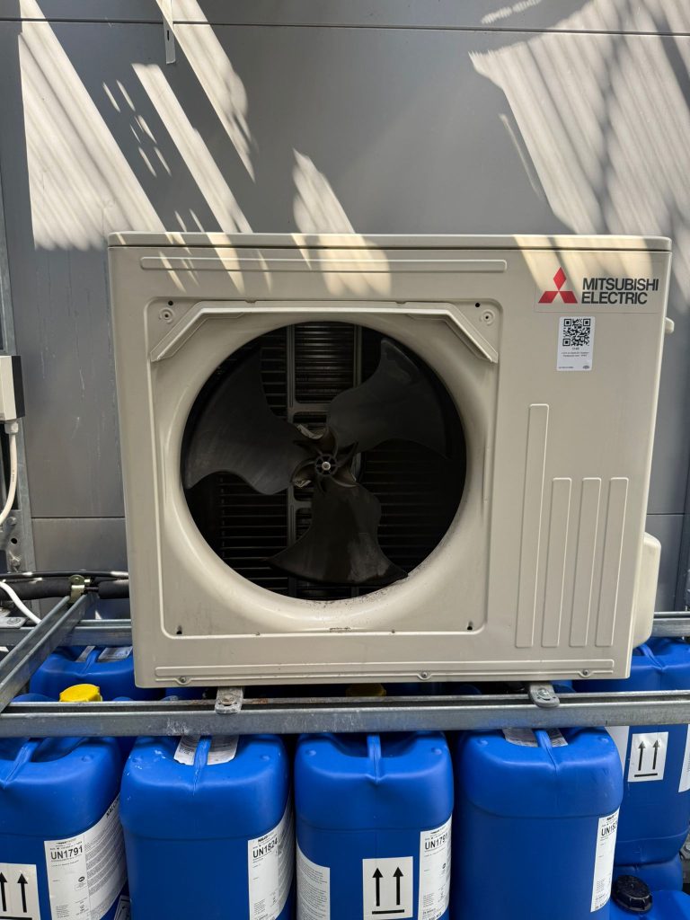 A HVAC unit with the fan removed prior to repair