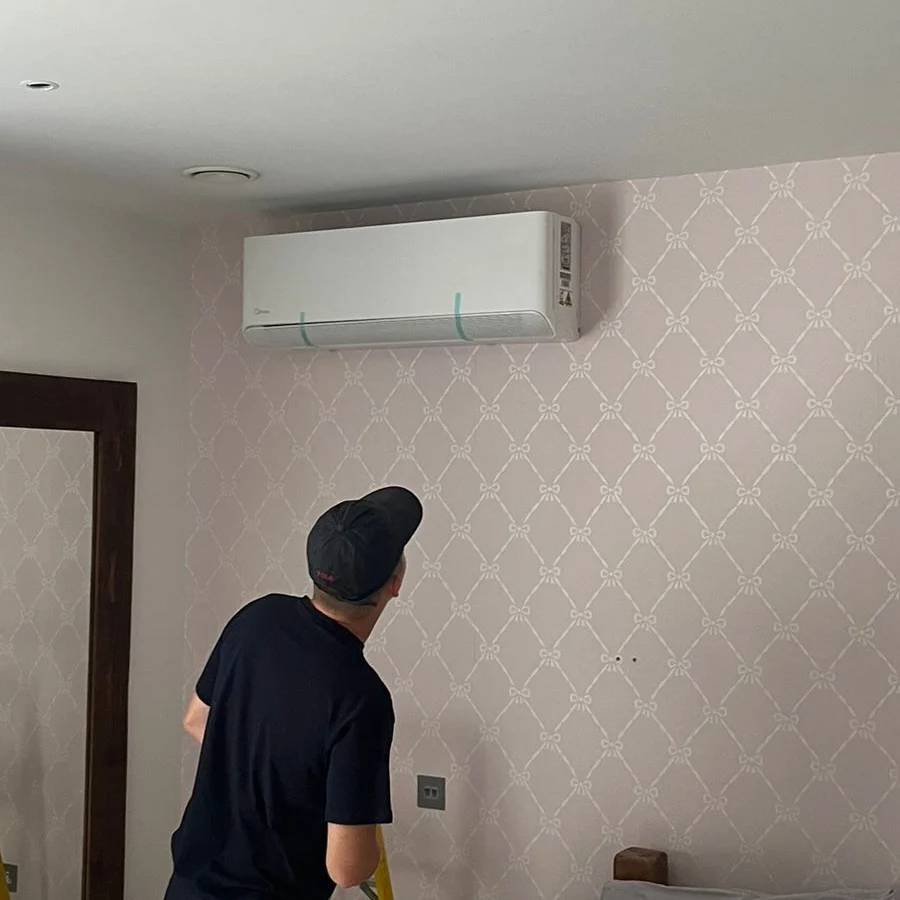 An engineer looking at an air conditioning unit